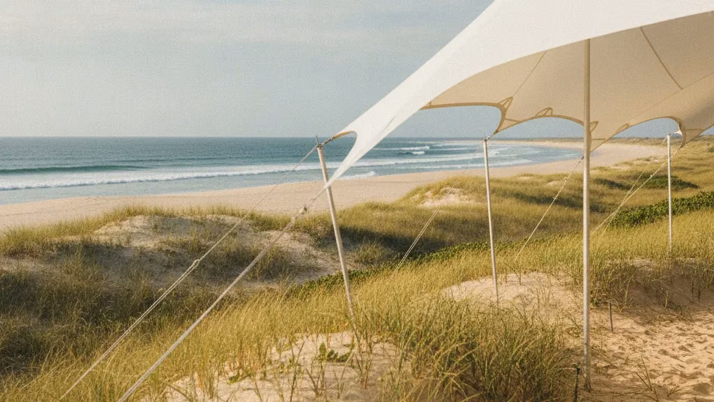 White stretch tent anchored on a beach dune beside the sea on the KZN south coast near Amanzimtoti