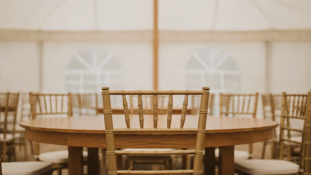 Gold Tiffany chairs around a round table inside a Durban function tent
